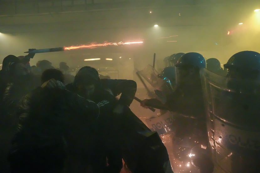Demonstrators clash with police during a protest against the Milan-Cortina 2026 Olympics, in Milan, Italy, Saturday Feb. 7, 2026. (Claudio Furlan/LaPresse via AP)