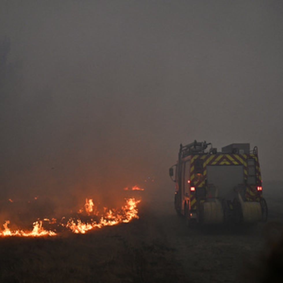 Un camión de bomberos avanza entre el humo de un incendio cerca de Marcheprime, a las afueras de Burdeos, Francia.