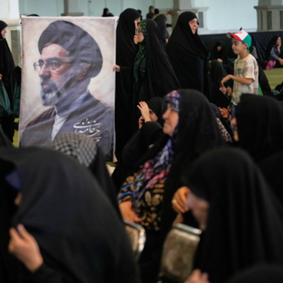 Women gather around a portrait of Iran’s Supreme Leader, Ayatollah Mojtaba Khamenei, during a ceremony honoring the armed forces and those killed in the war with Israel and the United States at the Grand Mosque of Imam Khomeini in Tehran, Iran.