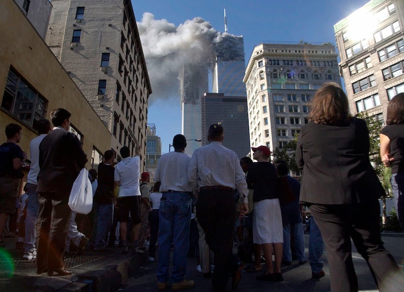 ARCHIVO - Peatones en el Bajo Manhattan observan el humo que se eleva del World Trade Center, el 11 de septiembre de 2001, en Nueva York. (AP Foto/Amy Sancetta, archivo)