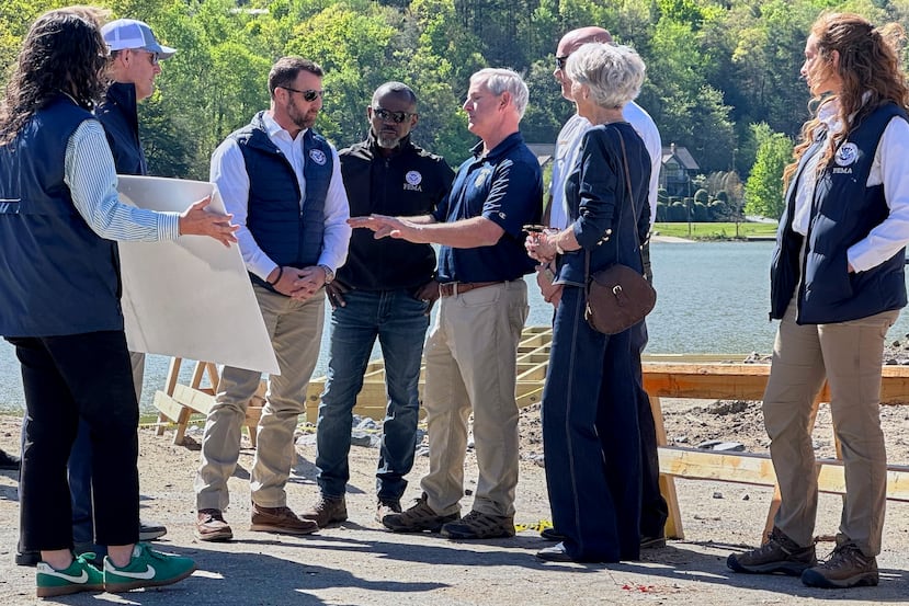 Homeland Security Secretary Markwayne Mullin, center left, listens to a briefing on hurricane recovery efforts, Tuesday, April 7, 2026 in Lake Lure, N.C. This is his first official trip since replacing Kristi Noem. (AP Photo Rebecca Santana)