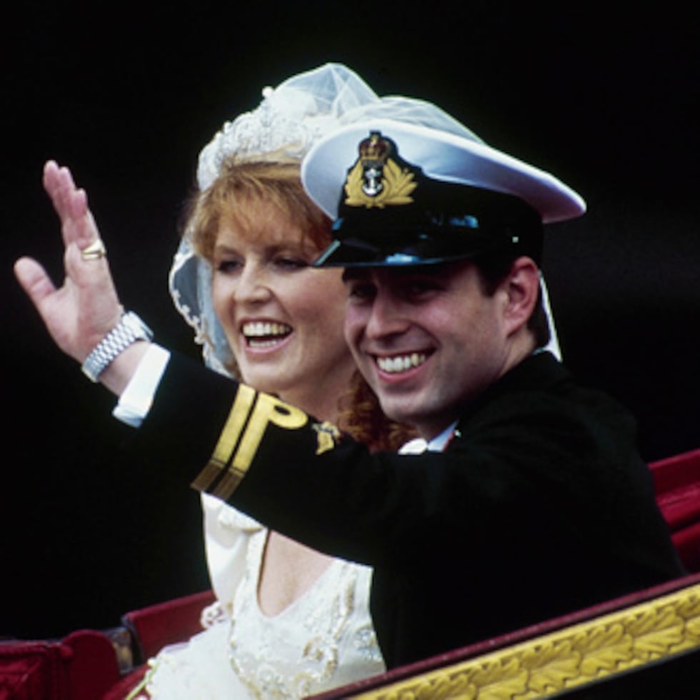 ARCHIVO - El príncipe británico Andrés, junto con su esposa Sarah, saluda desde su carruaje tirado por caballos al salir de la Abadía de Westminster tras su boda en Londres, el 23 de julio de 1986. (Foto AP/Dave Caulkin, Archivo)