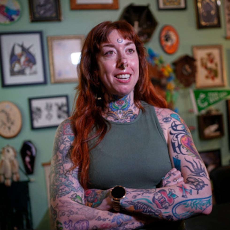Tattoo artist Mischa Ostberg talks with a visitor at the Ghost Rose Tattoo parlor, Nov. 3, 2025, in Ellsworth, Maine. (AP Photo/Robert F. Bukaty)