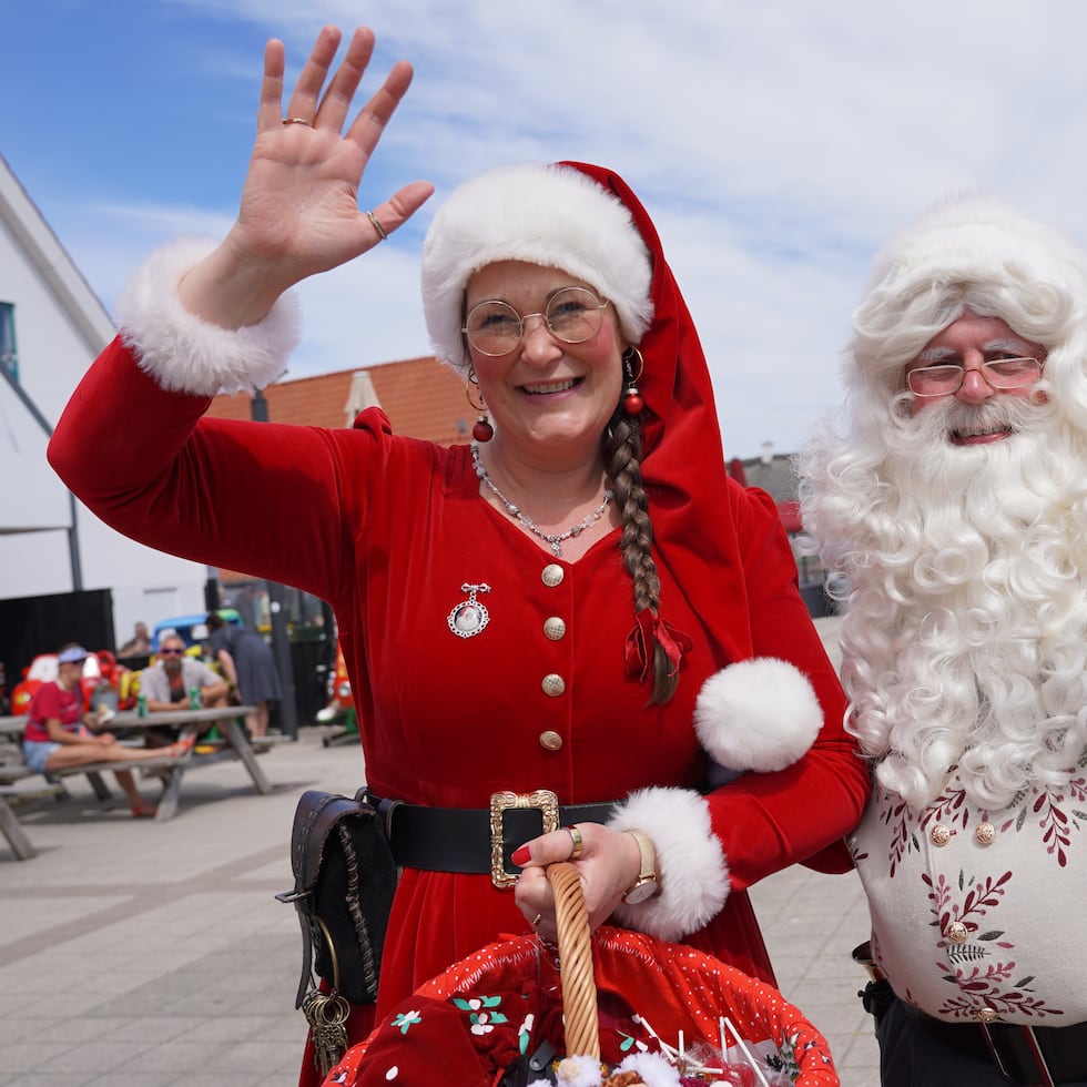 Un intérprete disfrazado de Santa Claus y otro de elfo navideño saludan a la cámara durante el Congreso Mundial anual de Santa Claus, una colorida tradición de mediados de verano, en Aalborg, Dinamarca.