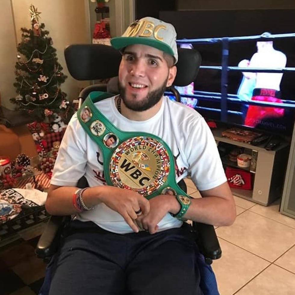 Prichard Colón holds a World Boxing Organization (WBO) championship belt gifted to him.