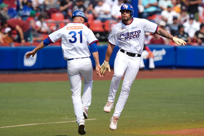 Yohandy Morales, de Puerto Rico, a la derecha, y Ricardo Rivera celebran luego de anotar con un jonrón de dos carreras ante México en la Serie del Caribe.