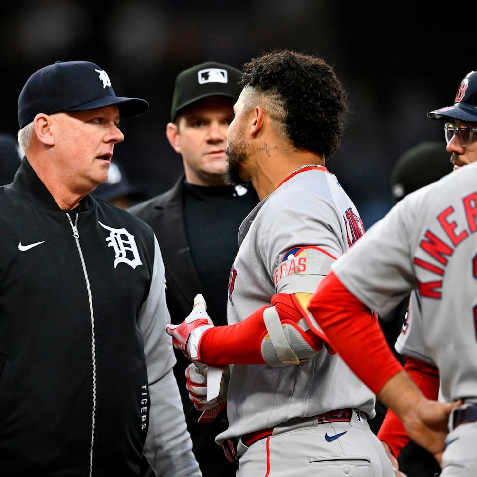 El dirigente de los Tigers de Detroit, A. J. Hinch (izquierda) conversa con Willson Contreras, de los Red Sox de Boston, después de que Trevor Story fuera golpeado por un lanzamiento.
