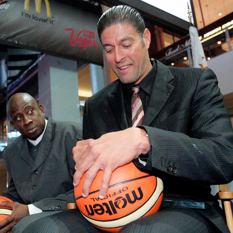 FIBA hall of fame basketball player Jose "Piculin" Ortiz, right, of Puerto Rico, and NBA basketball player Carl Herrera, of Venezuela, sign balls during a draw for The FIBA Americas Championship at The Fashion Show Mall in Las Vegas on Wednesday, March 21, 2007. (AP Photo/Eric Jamison, File)