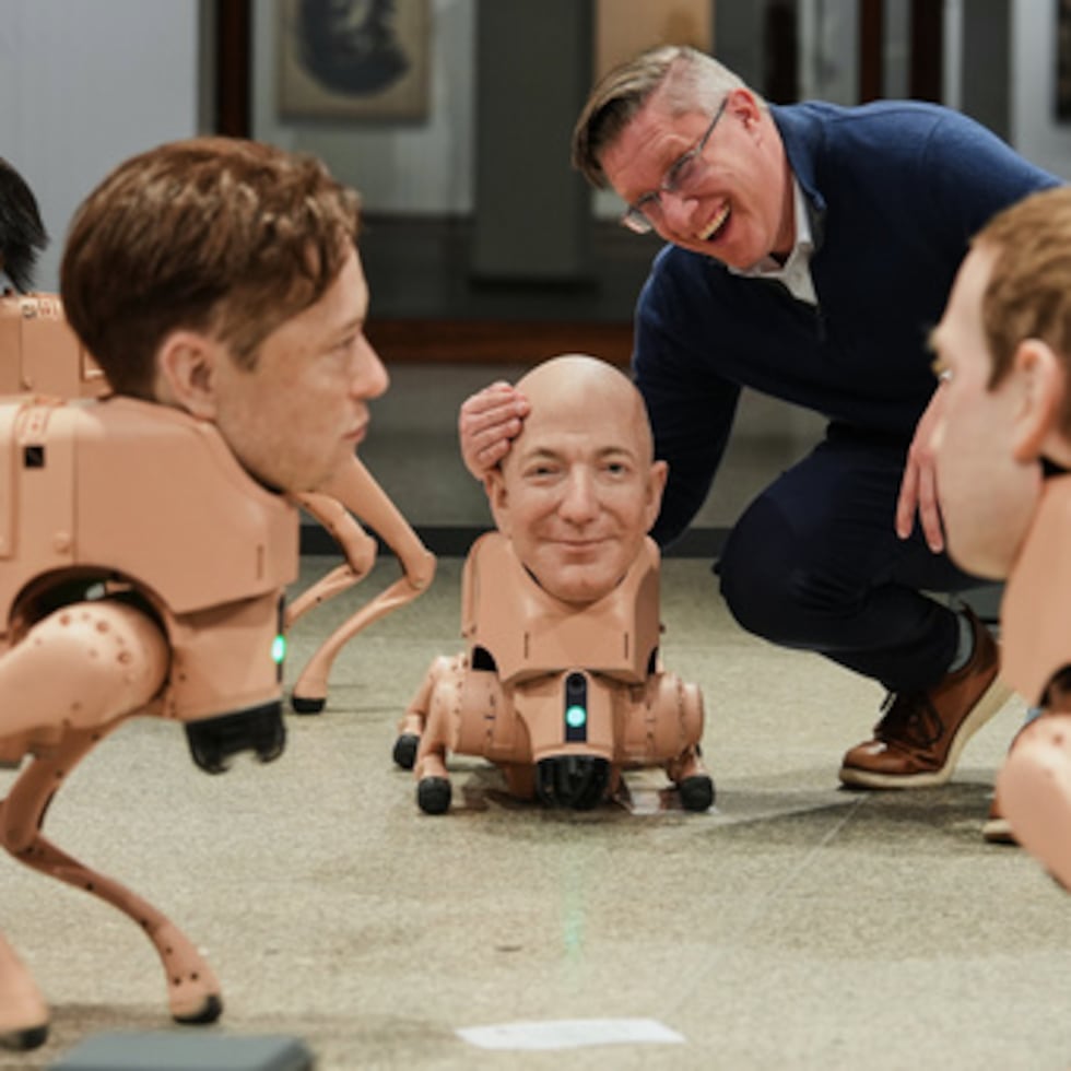 El artista Beeple, Mike Winkelmann, posa dentro de su instalación titulada Regular Animals, con robots a semejanza de Kim Jong Un, a la izquierda, Elon Musk, segundo a la izquierda, Jeff Bezos, en el centro, y Mark Zuckerberg, a la derecha, en el museo Neue Nationalgalerie de Berlín, Alemania, el martes 28 de abril de 2026. (AP Photo/Markus Schreiber)