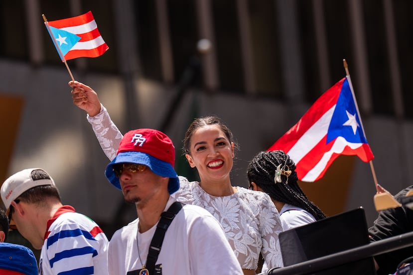 Rep. Alexandria Ocasio-Cortez, D-N.Y., takes part in the National Puerto Rican Day Parade, Sunday, June 14, 2026 in New York. (AP Photo/Adam Gray)