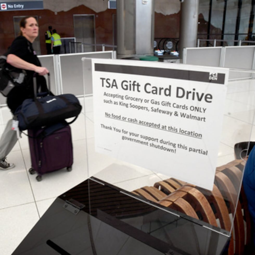 Un viajero pasa por delante de una caja de donación de tarjetas regalo para los agentes de TSA en el Aeropuerto Internacional de Denver.