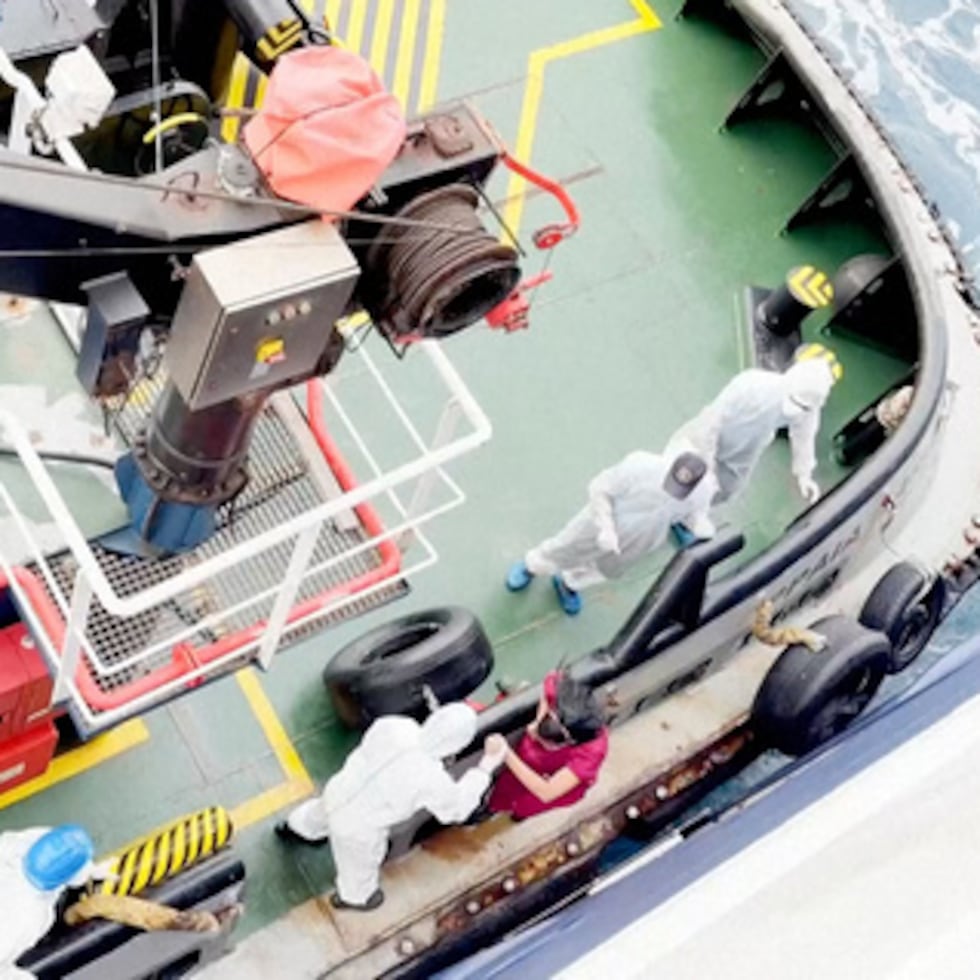 Trabajadores sanitarios bajan del MV Hondius, un crucero que transportaba a casi 150 personas, mientras permanece frente a Cabo Verde después de que tres pasajeros murieran y varios más enfermaran gravemente en un presunto brote de hantavirus.