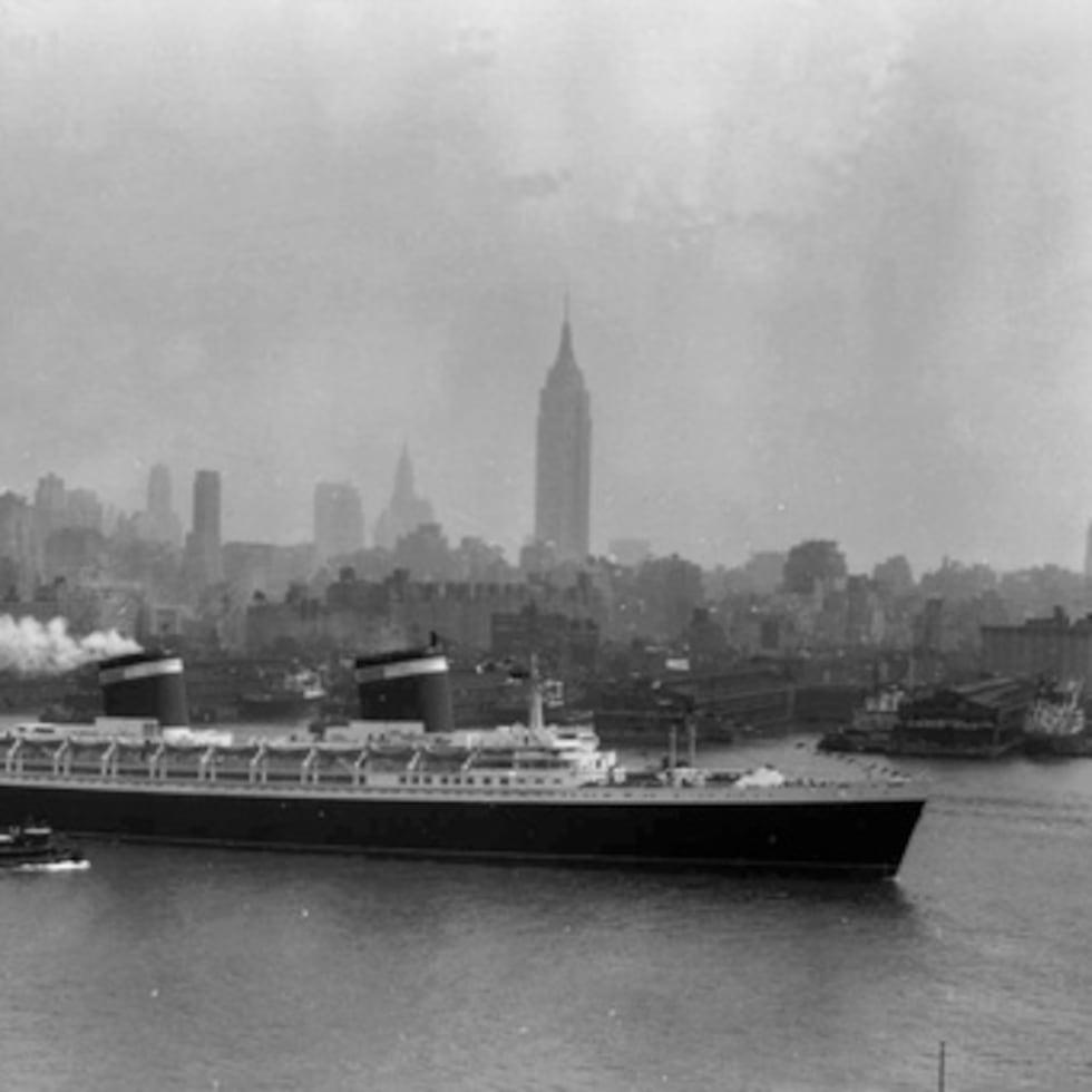 FILE - The SS United States travels along the Hudson River as it begins its first voyage to Europe from New York, July 3, 1952, with the view of the Midtown Manhattan skyline including the Empire State Building at center right. (AP Photo/Jack Harris, File)
