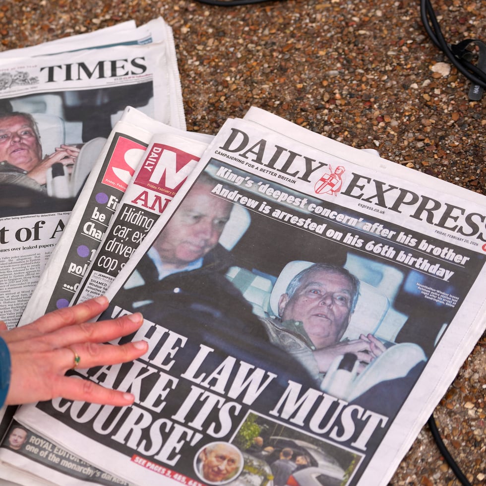 Un periodista mira las portadas de los periódicos de hoy en Londres, viernes 20 de febrero de 2026, después de que Andrew Mountbatten-Windsor fuera arrestado y retenido durante horas por la policía británica bajo sospecha de mala conducta en un cargo público relacionado con sus vínculos con Jeffrey Epstein.