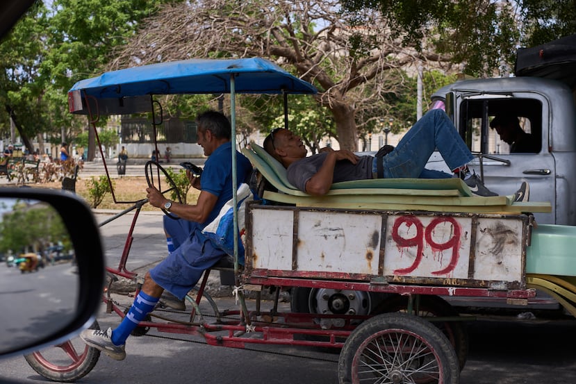 A man rests on mattresses atop a bicycle trailer in Havana, Wednesday, April 22, 2026. (AP Photo/Ramon Espinosa)