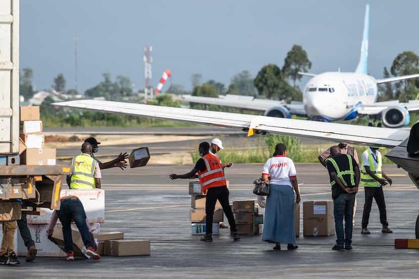 People offload supplies at Bunia National Airport as part of the response to the Ebola virus outbreak in Bunia, Congo, Tuesday, May 19, 2026. (AP Photo/Moses Sawasawa)