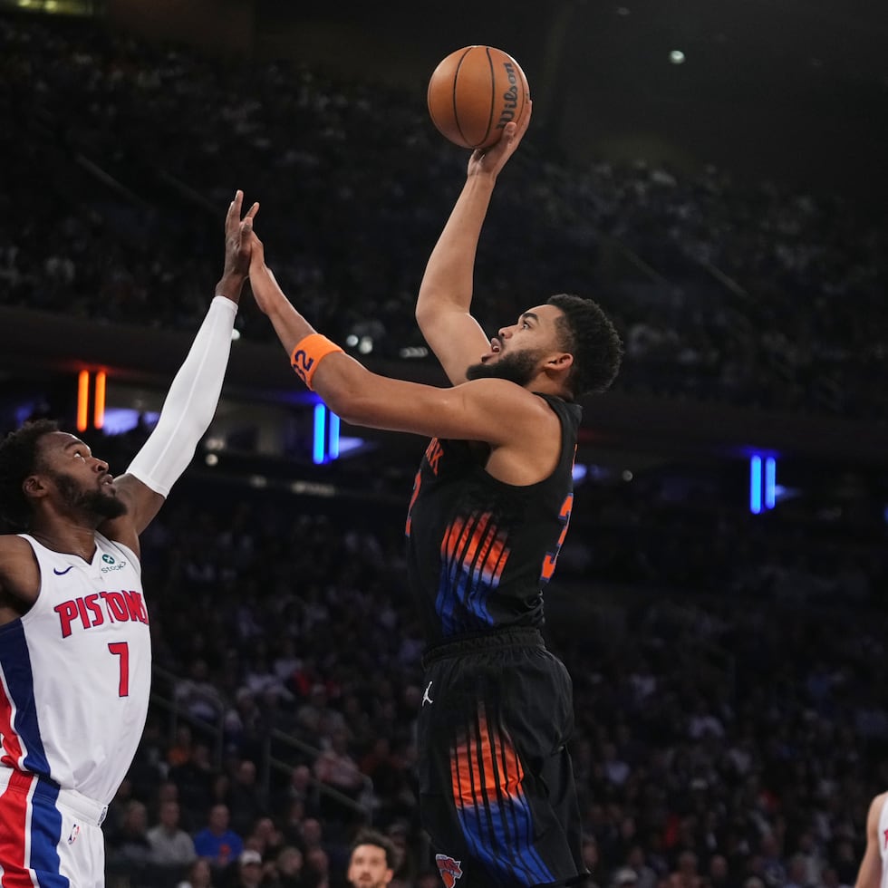 El dominicano Karl-Anthony Towns, de los Knicks de Nueva York, tira al canasto frente a Paul Reed, de los Pistons de Detroit.