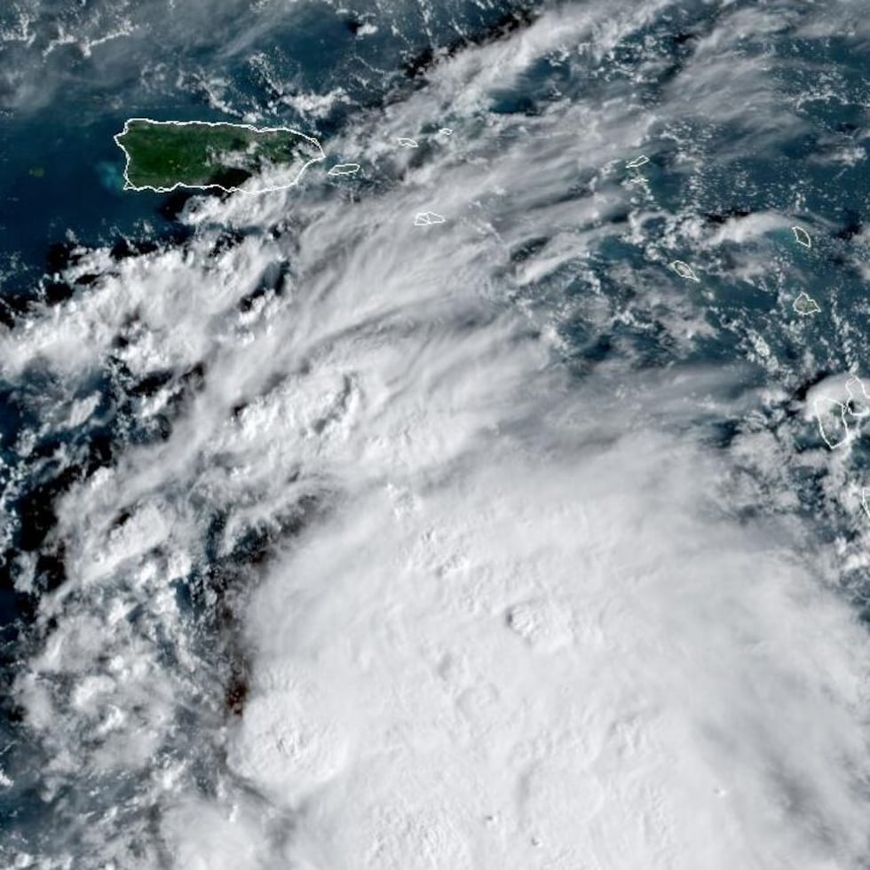 The image shows tropical wave Invest 98L passing south of Puerto Rico, over the Caribbean Sea.