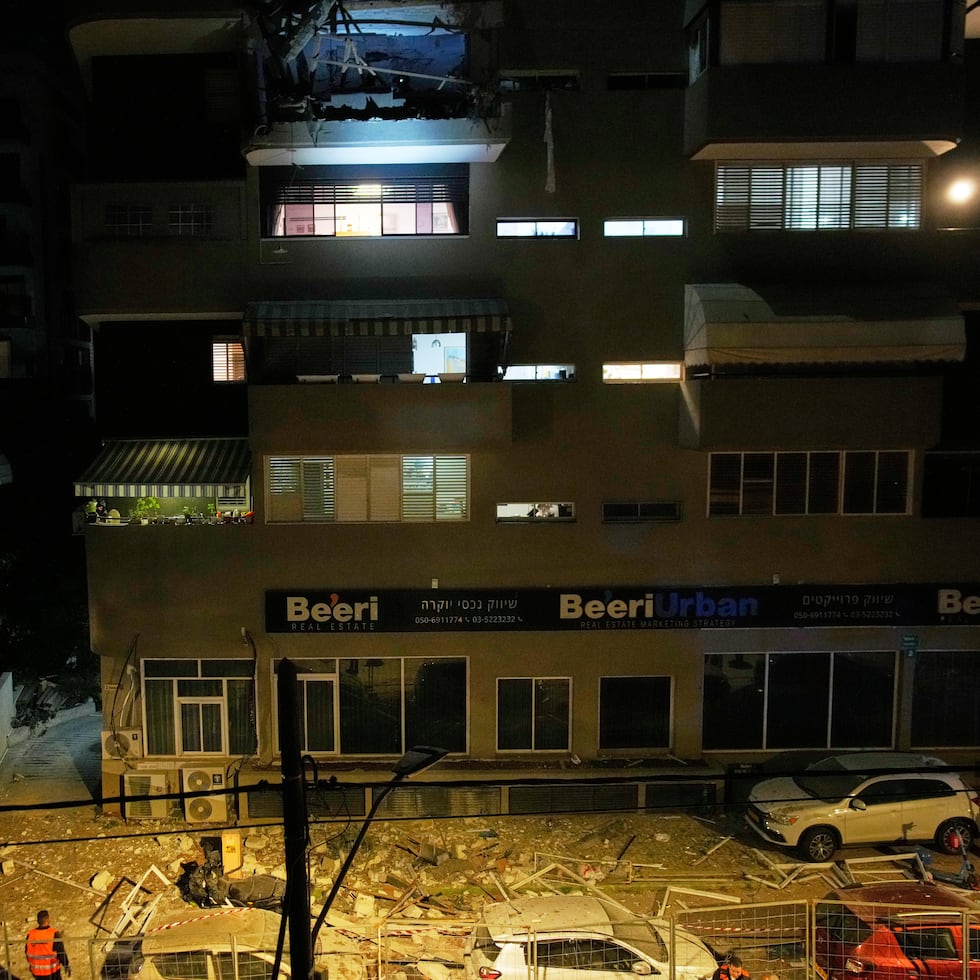 Las fuerzas de seguridad israelíes inspeccionan el lugar donde un misil iraní causó la muerte de dos personas en Ramat Gan, Israe.