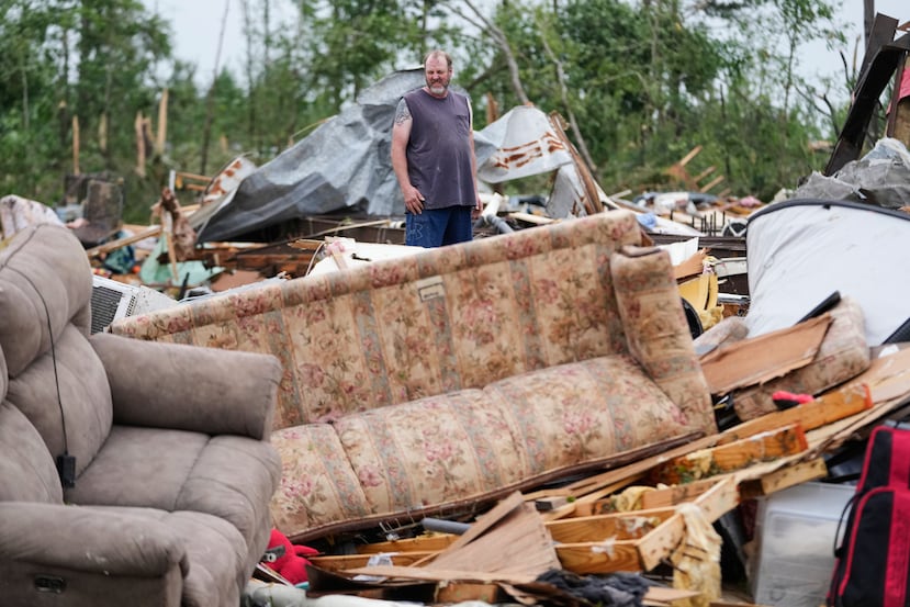 A man stands among debris at Gene's Mobile Home Supply, a trailer park in Bogue Chitto, Miss., Thursday, May, 7, 2026, after a tornado cut across the state. (AP Photo/Gerald Herbert)