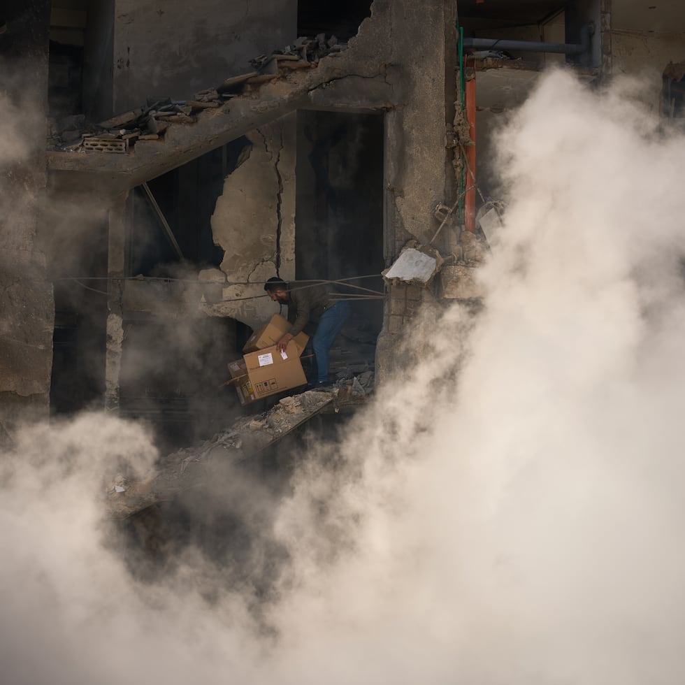 Un hombre recoge sus pertenencias de su casa, que fue destruida en un ataque aéreo israelí el día anterior en Beirut, Líbano.