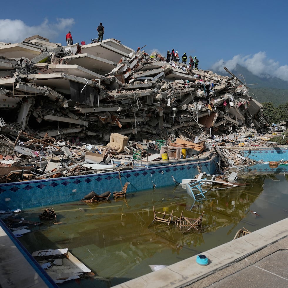 Los equipos de rescate buscan entre los escombros tres días después de que los terremotos azotaran Catia La Mar.