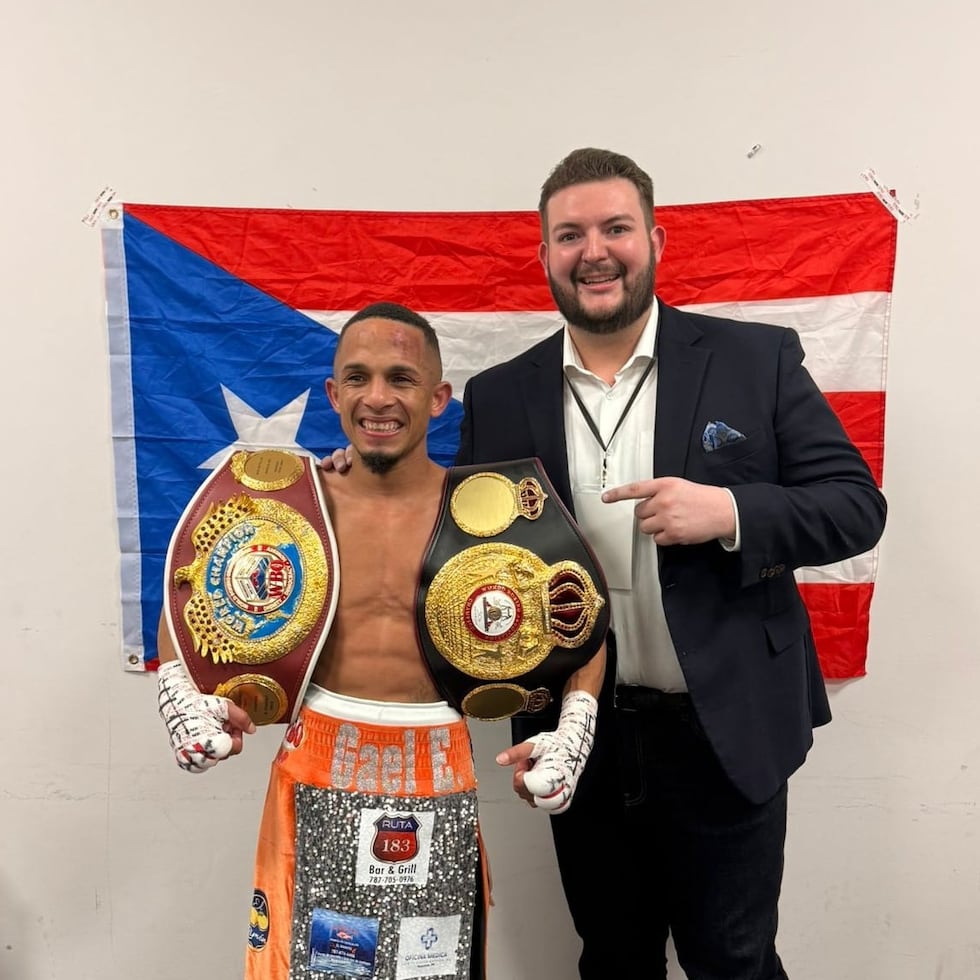 Rene "Chulo" Santiago (left) poses with his two 108-pound belts next to Félix Zabala III.