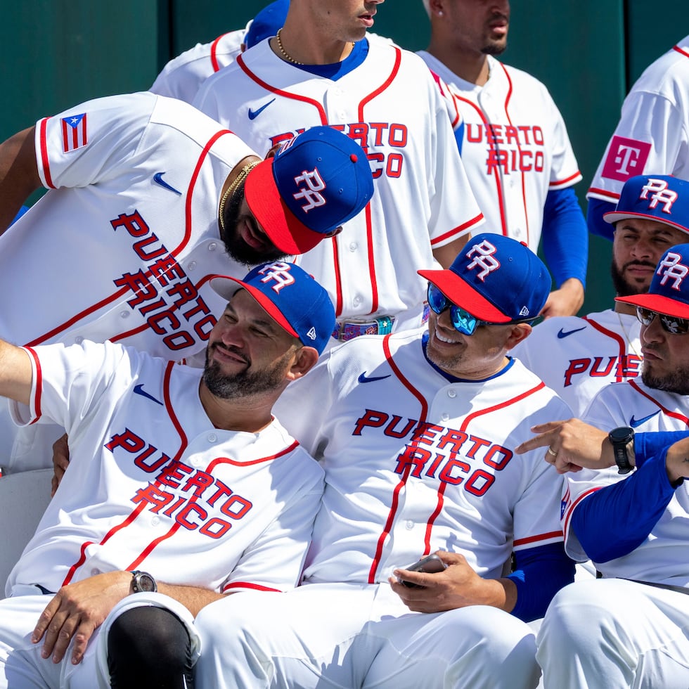 Yadier Molina, right, shares with players during a photo session at the Bithorn field.