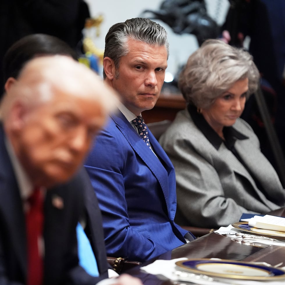 El secretario de Defensa, Pete Hegseth, escucha mientras él y la jefa de despacho de la Casa Blanca, Susie Wiles, acompañan al presidente Donald Trump.