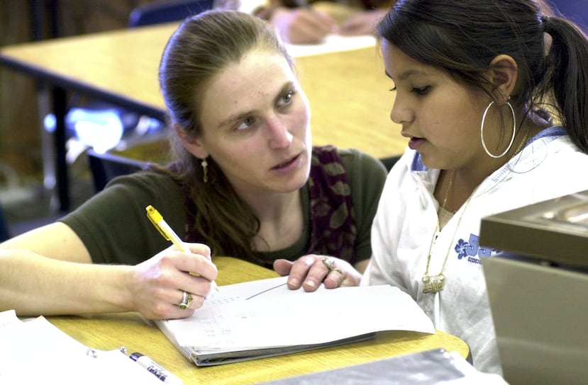 Special education instructor Michelle Harper, left, works on math problems with Erika Rodriguez at White Mountain Middle School in Eagle Point, Ore., Oct. 28, 2003. Parents and teachers of special education students have fought hard for funding and for students to be mainstreamed and now the new law, dubbed No Child Left Behind, has turned more attention onto special education because of the resulting consequences for all segments of public schools. The federal law mandates that schools bring all students up to grade level on reading and math standardized tests, including special education students and those who don't speak English.(AP Photo/Don Ryan)