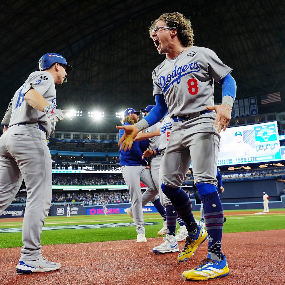 Enrique "Kike" Hernández celebrating Saturday after Miguel Rojas connected on a home run in the ninth inning to tie the game 4-4.