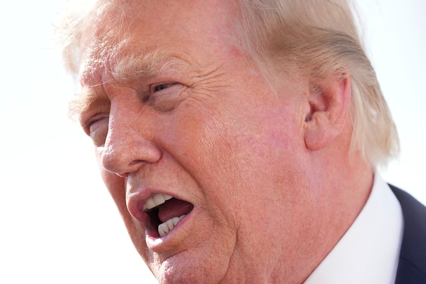 President Donald Trump speaks with reporters before boarding Air Force One, Friday, Aug. 21, 2026, at Joint Base Andrews, Md., en route to South Carolina. (AP Photo/Jacquelyn Martin)