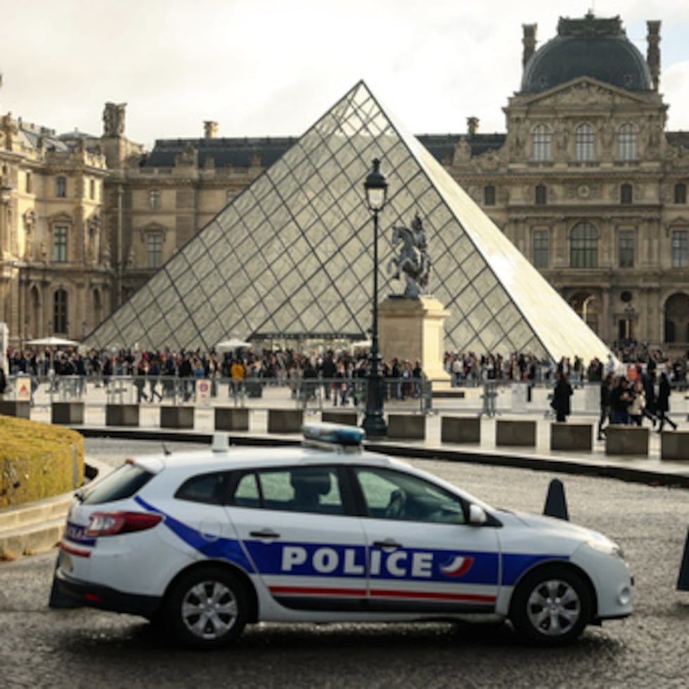 ARCHIVO - Un coche de policía aparca en el patio del museo del Louvre, una semana después del robo, el 26 de octubre de 2025, en París. (AP Photo/Thomas Padilla, Archivo)