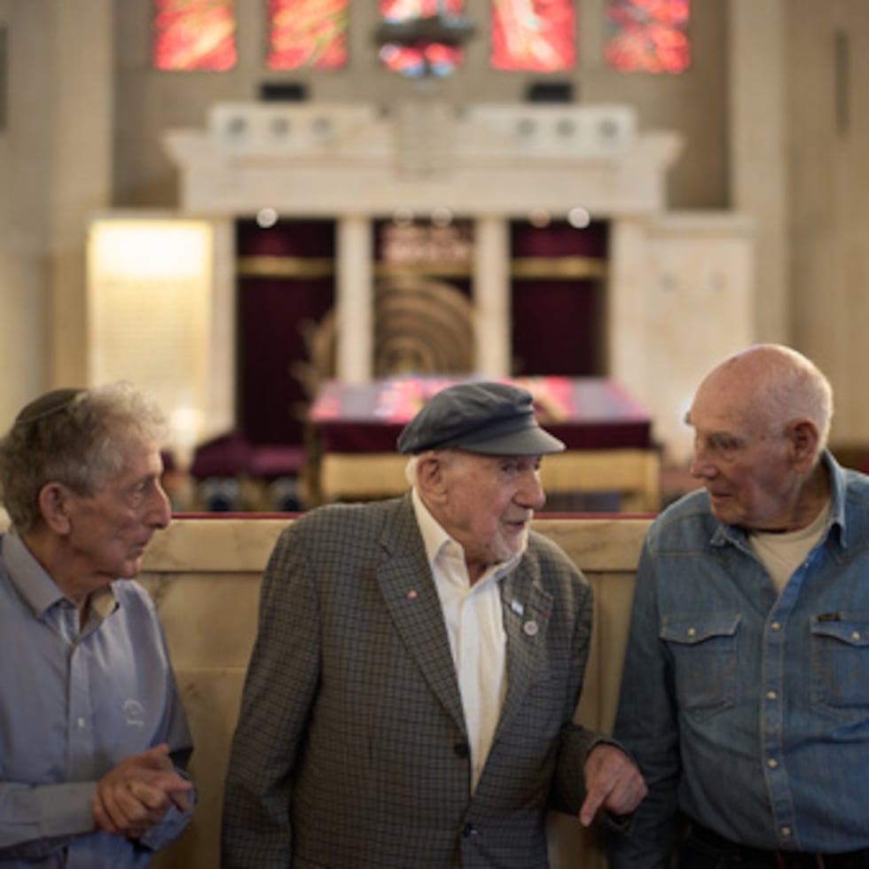 Holocaust survivors Walter Bingham, 101, center, George Shefi, 94, right, and Paul Alexander, 87, talk as they pose for a photo after an interview at Jerusalem Great Synagogue in Jerusalem, Wednesday, Nov. 5, 2025, ahead the 87th anniversary of Kristallnacht or "Night of broken Glass," the November 1938 government-backed pogroms against Jews in Germany and Austria. (AP Photo/Leo Correa)