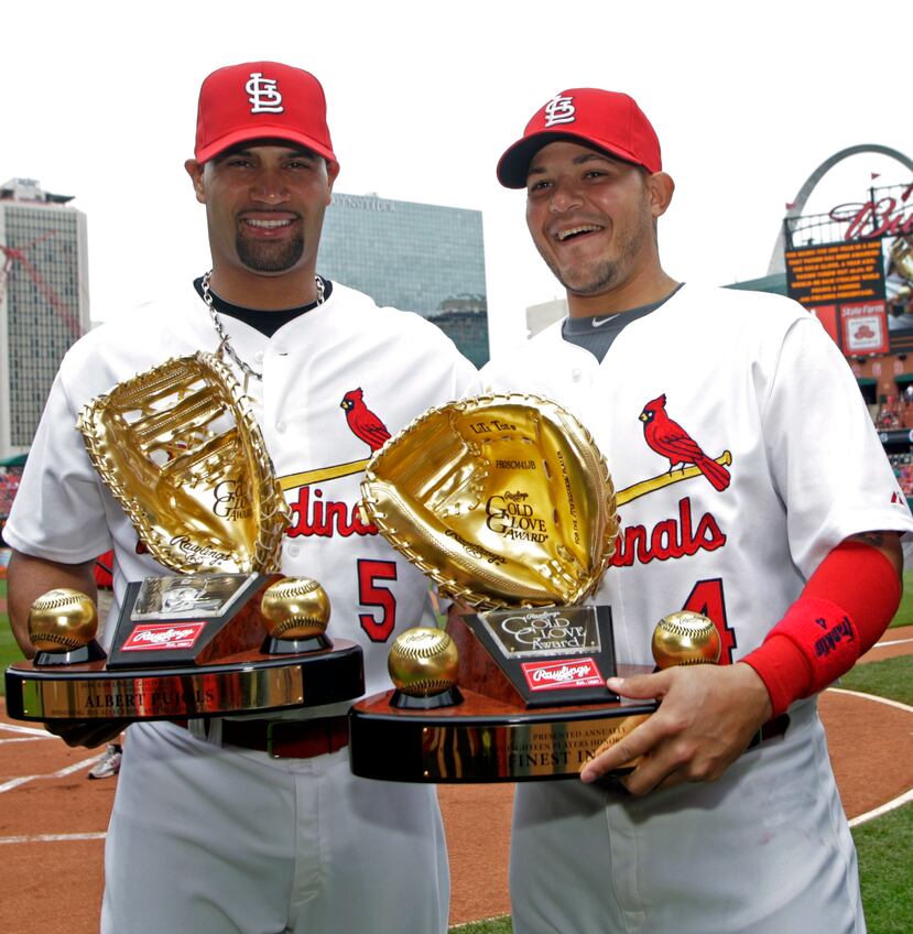 El primera base de los Cardenals de San Luis Albert Pujols, izquierda, y el receptor Yadier Molina reciben sus premios Guante de Oro antes de un partido de béisbol entre los Cardenals y los Reds de Cincinnati, el sábado 23 de abril de 2011.