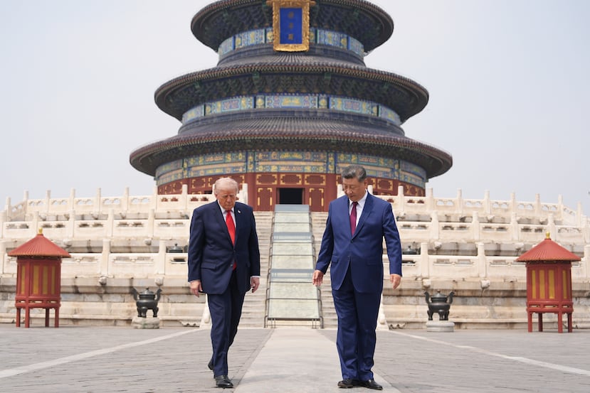 President Donald Trump, left, walks with Chinese President Xi Jinping at the Temple of Heaven on Thursday May 14, 2026, in Beijing. (AP Photo/Mark Schiefelbein)