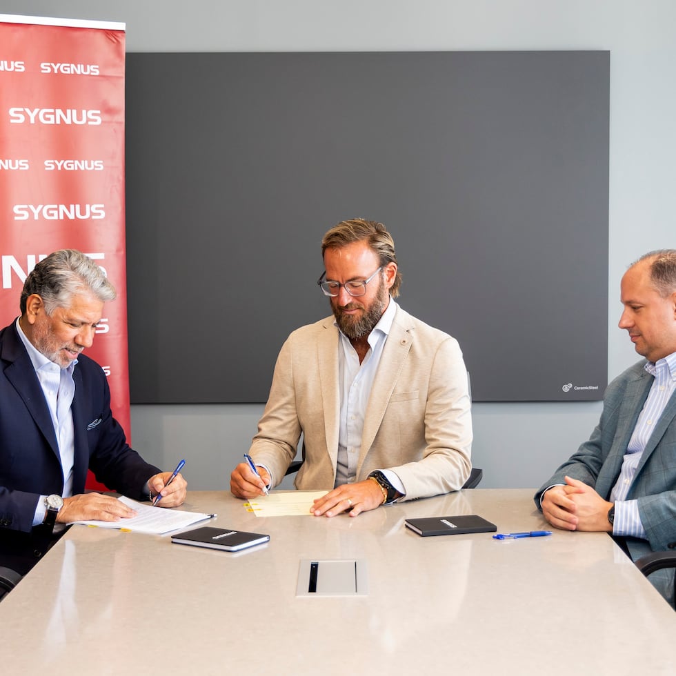 Eric Delgado and Matthew Williams, co-founder and chief investment officer of GCI Holdings; and Miguel Román, part of the Solaner Puerto Rico management team.