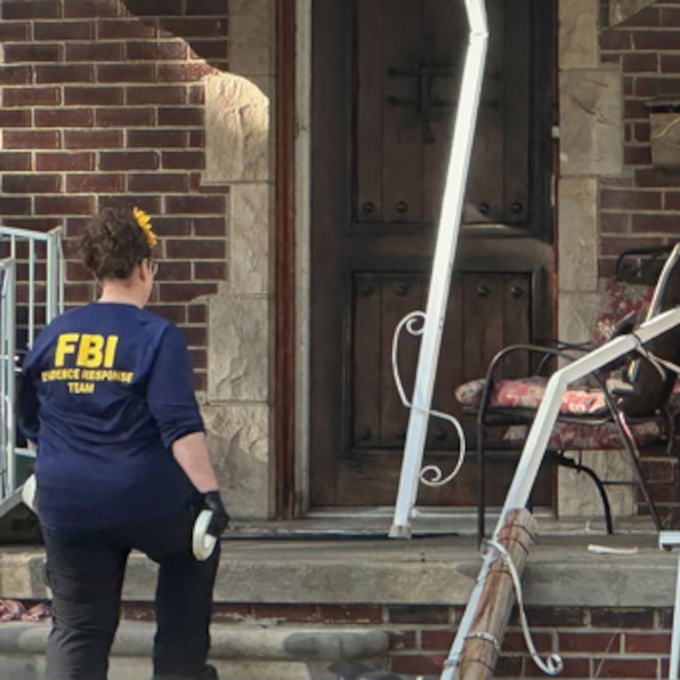 An FBI agent enters a home in a Dearborn, Mich., neighborhood on Friday, Oct. 31, 2025. (AP Photo/Mike Householder)
