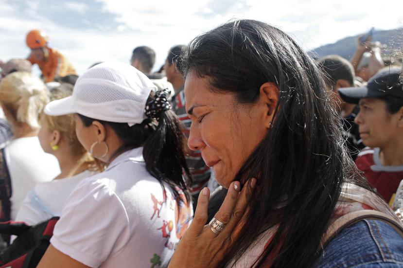 Una mujer llora al cruzar la frontera, mientras kioskos con música esperaban a los consumidores venezolanos.