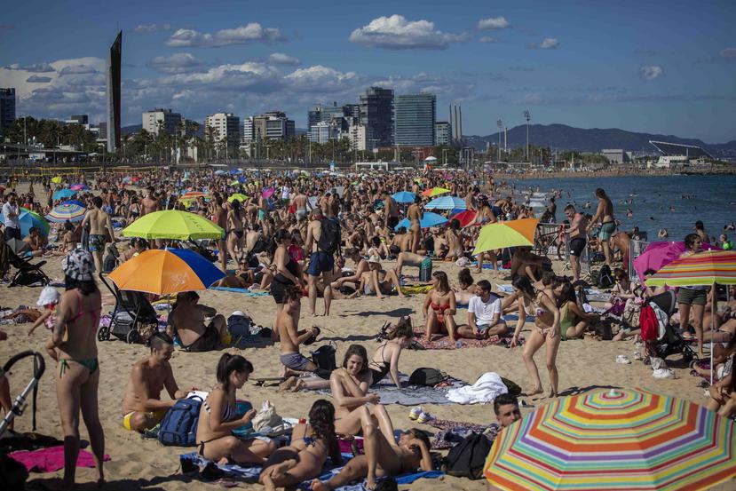 Personas disfrutan del clima cálido en la playa de Barcelona, España, el sábado 13 de junio de 2020. (AP Foto/Emilio Morenatti)