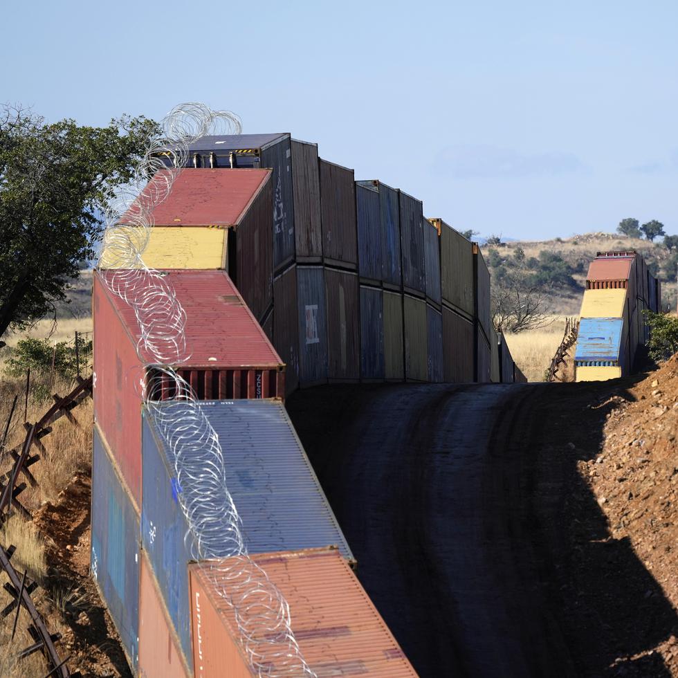 Una hilera de contenedores de transporte apilados en la frontera entre Estados Unidos y México en la lejana sección de San Rafael Valley, Arizona.