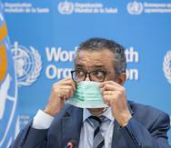 Tedros Adhanom Ghebreyesus, director general de la OMS, se apresta a retirarse la mascarilla antes de hablar a los medios de comunicación sobre la pandemia de COVID-19 y las prioridades de la organización en 2022, durante una conferencia de prensa en Ginebra, Suiza.