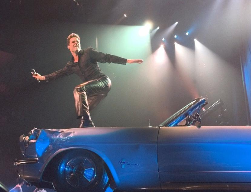 File photo of Ricky Martin dancing on top of a car as part of his performance at the premiere of his world tour "Livin' La Vida Loca Tour" on October 20, 1999 at the Miami Arena, in Miami.  (AP Photo/Wilfredo Lee)